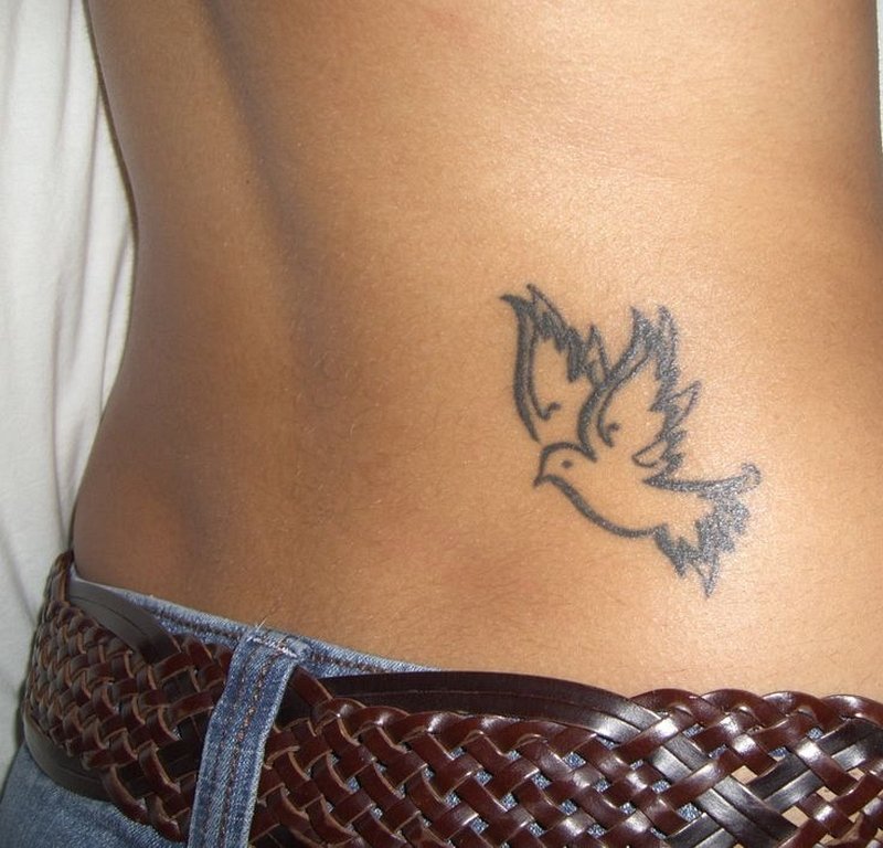 Minimalistic dove tattoo located behind the ear.